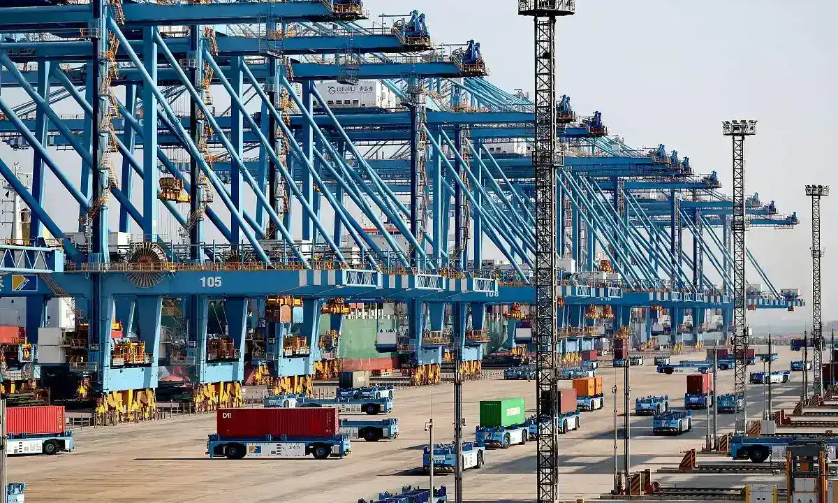Automated container terminal with blue ship-to-shore cranes and AGV fleet
