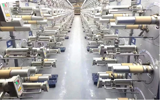 MS209A winder yarn path showing ceramic guide nozzle and traverse assembly